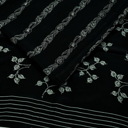 Black pure crepe silk saree fabric with white floral print on a black background
