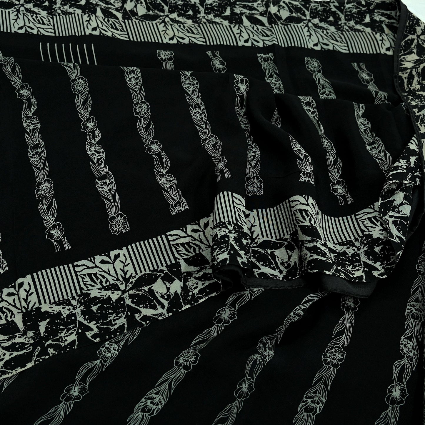 Black pure crepe silk saree fabric with white floral patterns and stripes