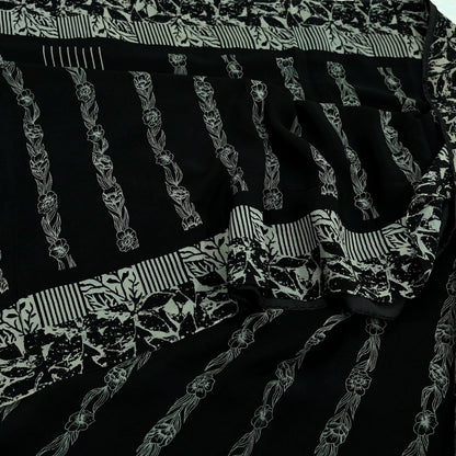 Black pure crepe silk saree fabric with white floral patterns and stripes