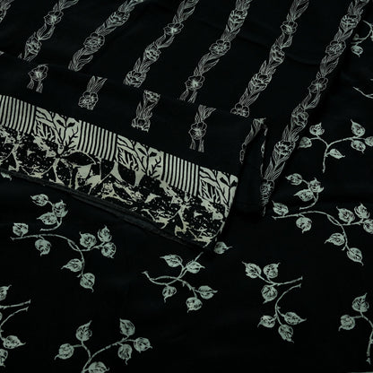Black pure crepe silk saree fabric with white floral patterns on a black background
