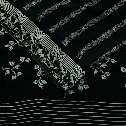 Decorative pure crepe silk saree fabric with floral and striped patterns on a black background