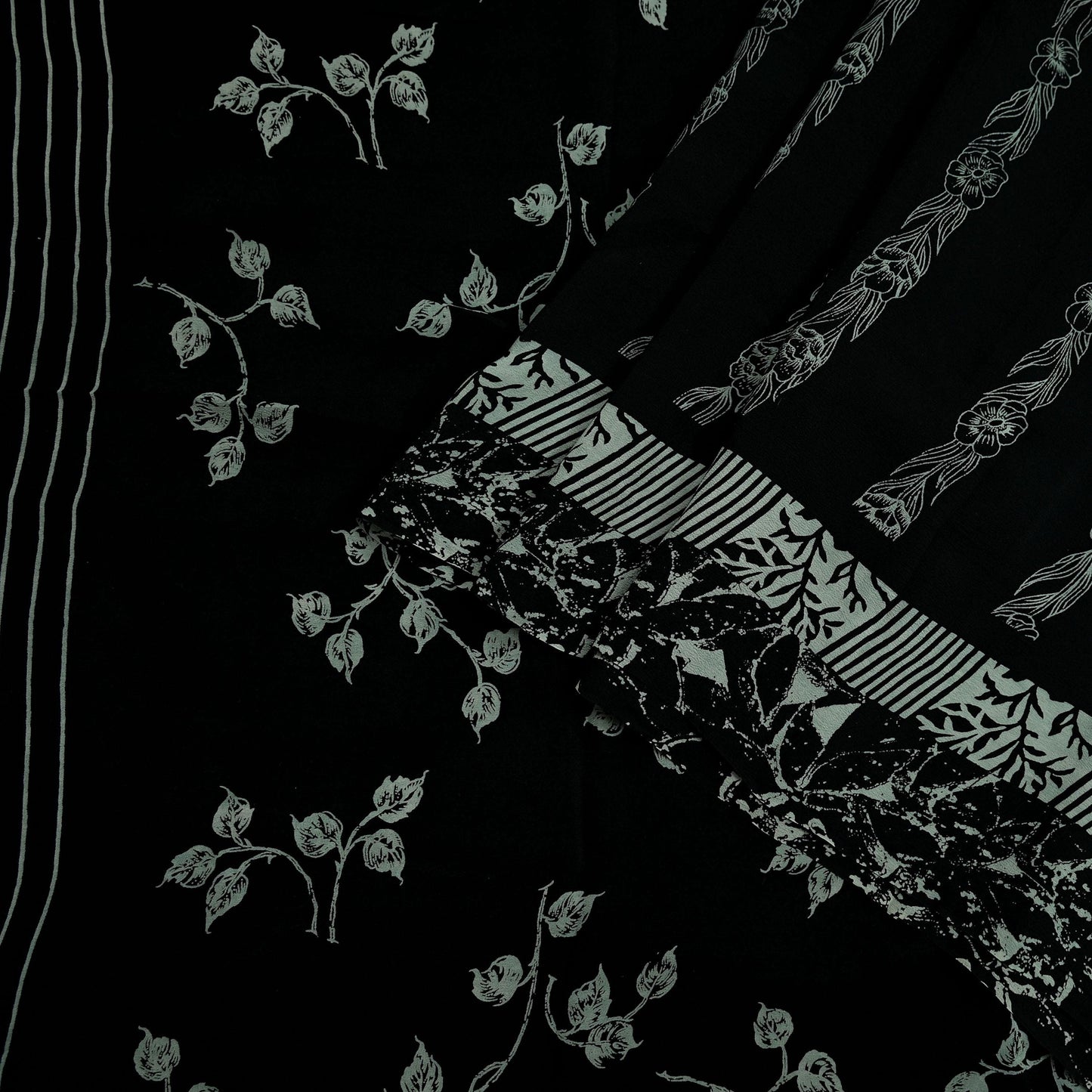 Black pure crepe silk saree fabric with white floral prints on a black background