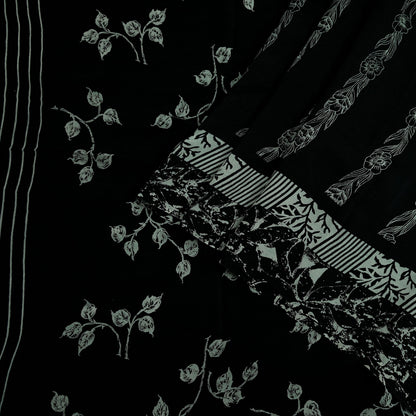 Black pure crepe silk saree fabric with white floral prints on a black background