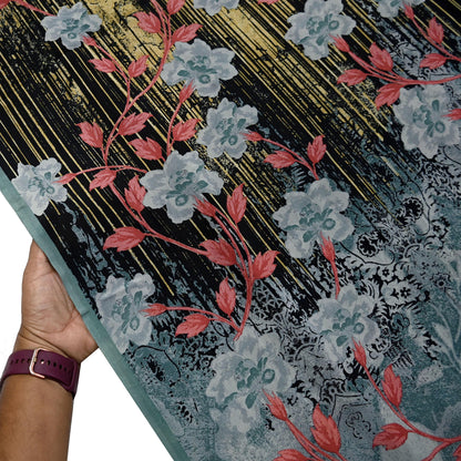 Floral-patterned fabric held by a hand.