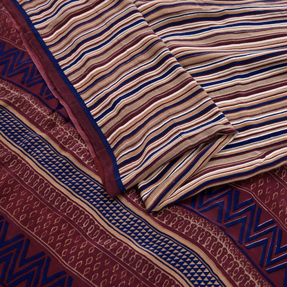 Close-up of patterned fabric with stripes and geometric designs.