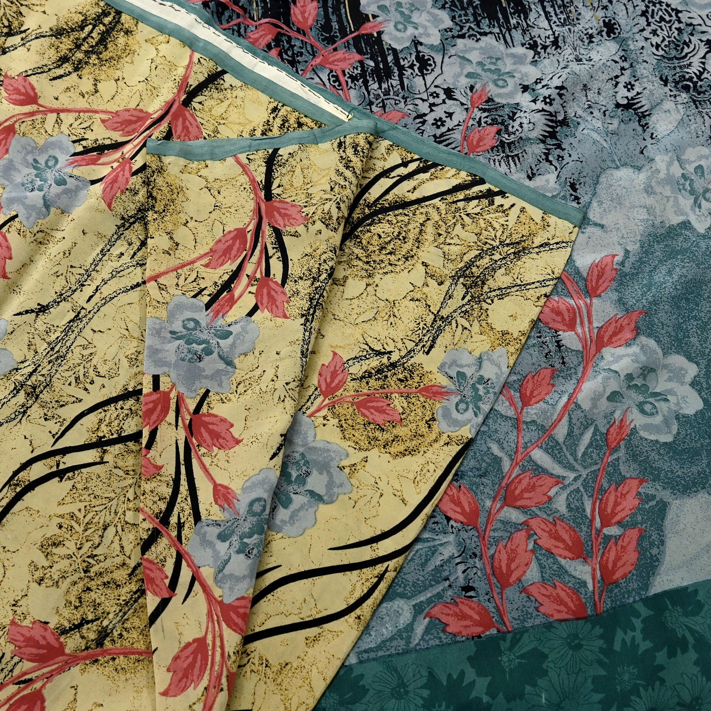 Floral patterns in red, blue, and beige on a printed silk fabric.