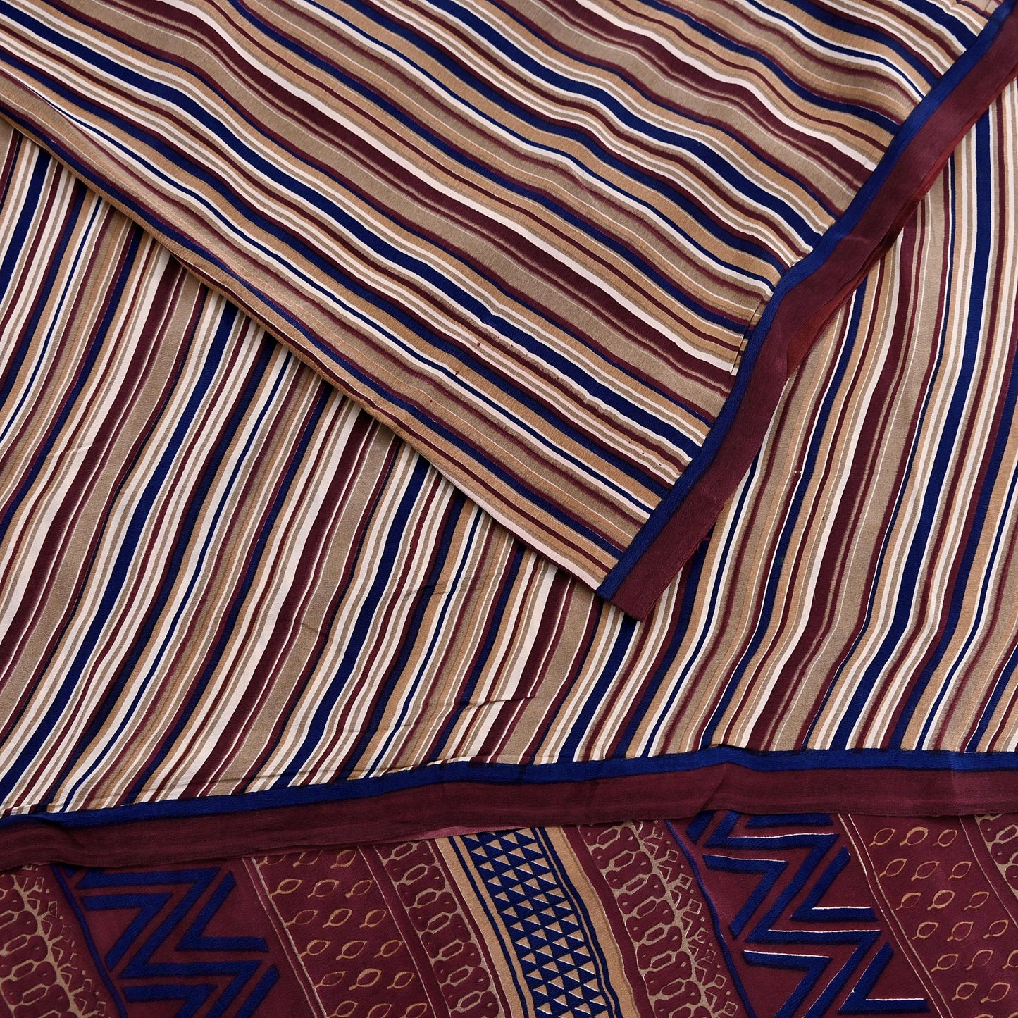 Striped fabric with a geometric pattern in brown, blue, and beige.