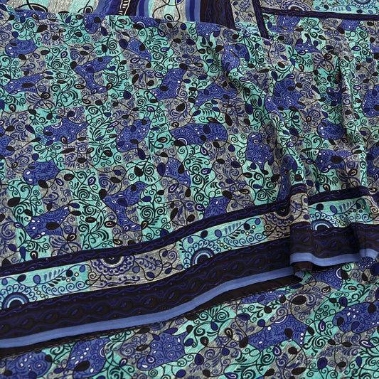 Close-up of a printed pure crepe silk saree fabric with blue and green design
