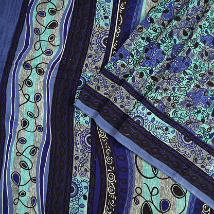 Close-up of a vintage pure crepe silk saree fabric with intricate blue and green patterns