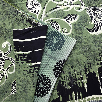 Black and white striped design on a textured green pure crepe silk saree fabric with floral patterns