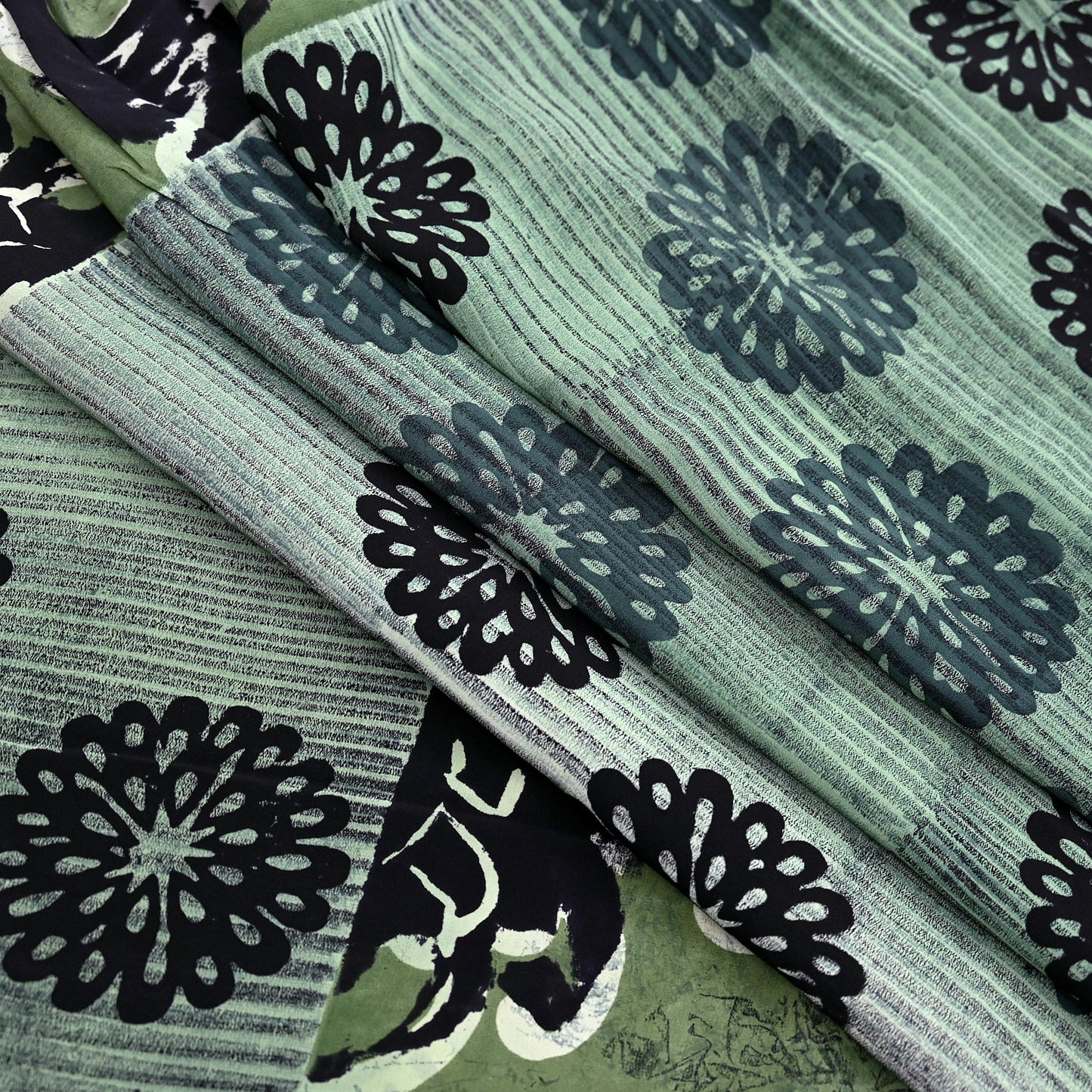 Vintage pure crepe silk saree with black floral patterns on a green and gray striped background