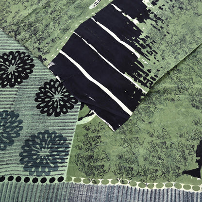 Creative shot of green and black patterned pure crepe silk saree fabric