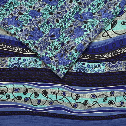 Creative shot of a blue and green pure crepe silk saree fabric with intricate prints.