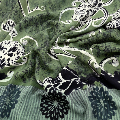 Green pure crepe silk saree with black and white floral patterns